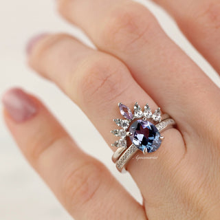 Alexandrite Curved Wedding Band in Sterling Silver by Aquamarise, showcasing an oval alexandrite center with marquise and round accent stones on a curved sterling silver band.