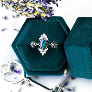 Artemisia Marquise Peacock Fire Opal Engagement Ring in Black Ruthenium in a teal velvet ring box