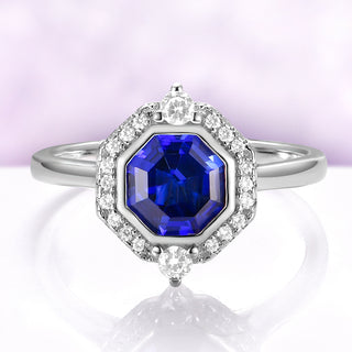 Asscher Cut Art Deco Bezel Set Blue Sapphire Ring in Sterling Silver by Aquamarise, featuring a deep blue sapphire surrounded by bezel and diamond accents on a polished silver band.