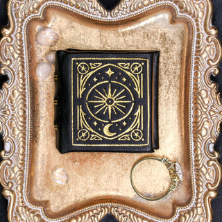 Black and gold handmade leather book ring box by Aquamarise with gilded embossed cover detail