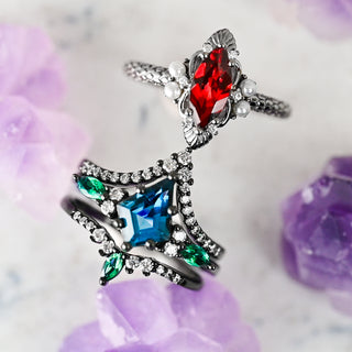 Black Engagement Rings, Elegant ring with red, blue, and green gemstones on a soft floral background