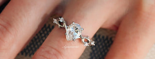 Silver ring with a large diamond on a finger