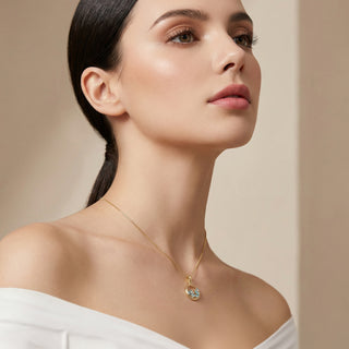Woman wearing a gold necklace with a heart-shaped pendant against a beige background