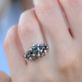 Carmilla gray moissanite and black onyx engagement ring in black ruthenium worn with its leaf and vine enhancer