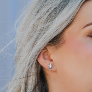Model wearing the Carmilla moissanite and amethyst stud earring in sterling silver, side profile