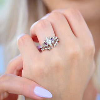 Carmilla Oval Moissanite and Amethyst engagement ring with the Leaf and Vine ring enhancer in sterling silver worn on the hand