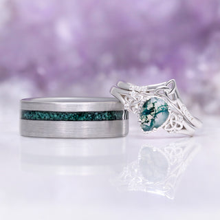 His and hers moss agate wedding rings side by side showing the tungsten inlay next to the pear cut Celtic knot ring