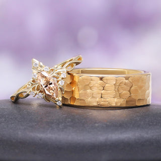 champagne moissanite lotus engagement ring with hammered tungsten band on gray surface over purple background