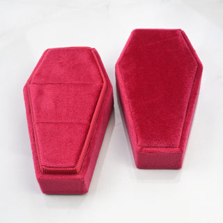 Red velvet coffin ring boxes shown closed from above