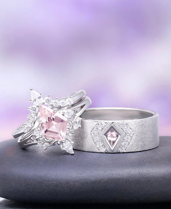 Two silver rings with pink gemstones on a gray surface and purple background