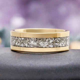 Close-up of the crushed simulated diamond inlay set flush between polished gold tungsten rails