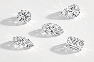 Collection of various cut diamonds on a light background