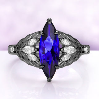 Eilwen Marquise Lab-Grown Blue Sapphire Leaf Engagement Ring in Black Ruthenium by Aquamarise, a tall 5 x 15 mm marquise sapphire framed by simulated diamond leaves