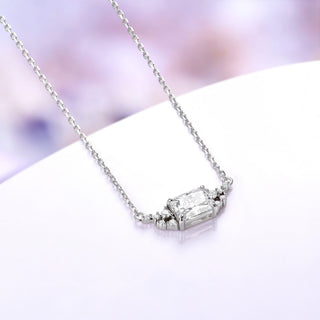 Sterling silver emerald cut moissanite necklace shown at an angle with its 18 inch cable chain