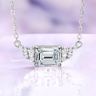 Emerald cut moissanite necklace in sterling silver, 6x8mm center stone set east-west with round moissanite accents