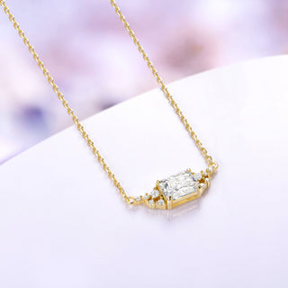 Yellow gold vermeil emerald cut moissanite necklace shown at an angle with its 18 inch cable chain