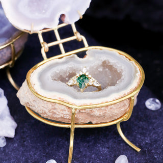 Natural geode ring boxes by Aquamarise displayed with moss agate rings, showing crystal-lined interiors and gold hinges