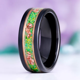 Green Fire Opal and rose gold leaf men's wedding band standing upright, black tungsten with a green opal inlay flecked with rose gold leaf