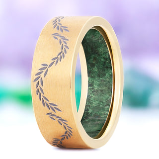 Green moss agate leaf men's wedding band in brushed gold titanium, 8mm, standing view showing the engraved laurel vine and the moss agate inner sleeve
