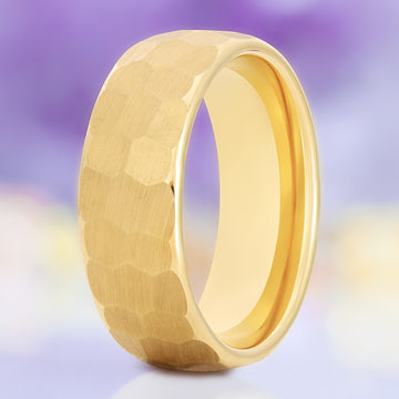 Hammered gold men's wedding band in yellow gold tungsten, 8mm, standing view showing the faceted brushed surface and polished interior