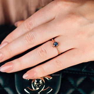 Vintage Alexandrite Fairytale Engagement Ring in 14K Rose Gold Vermeil by Aquamarise, featuring a petite teal and purple color-shifting alexandrite with delicate diamond accents on a hand.