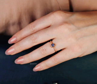 Vintage Alexandrite Fairytale Engagement Ring in 14K Rose Gold Vermeil by Aquamarise, featuring a color-shifting alexandrite and delicate diamond accents on a hand with natural nails.