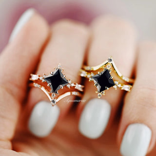 Black Onyx & Meteorite Gold Leaf Couples Ring Set by Aquamarise featuring sculpted gold bands with square black onyx stones and delicate meteorite gold leaf accents on paired hands with pale nail polish.