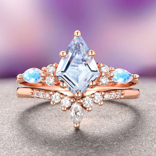 Rose gold ring with large central gemstone and smaller stones on a gradient background