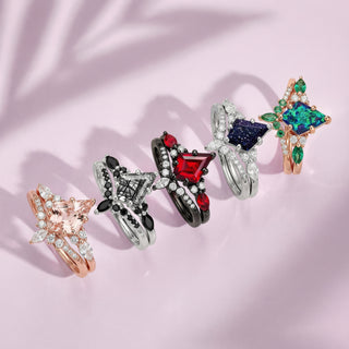 Five colorful rings on a pink fabric background