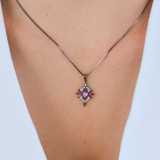 Model wearing the Nightbriar lab-grown ruby pendant necklace in black ruthenium