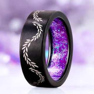 Laurel Vine & Lavender Opal men's wedding band in brushed black titanium, 8mm, standing upright showing the engraved laurel vine and the lavender opal inner sleeve