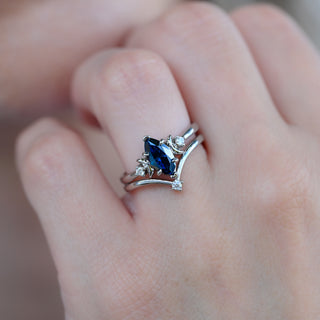 Midnight blue moissanite crescent moon engagement ring set worn on a model's hand