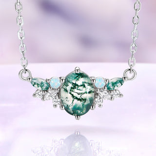 Moss agate and opal cluster necklace in sterling silver with an oval green moss agate center and white opal accents