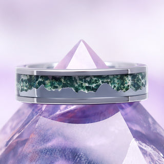 mountain range moss agate tungsten wedding band on purple crystal pyramid over purple background 