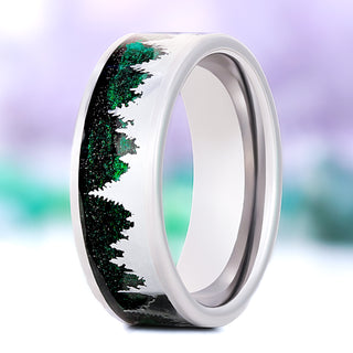 Northern Lights pines men's wedding band in polished tungsten, 8mm, standing view showing the silver pine silhouettes against the green sandstone inlay