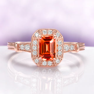 Vintage Halo Padparadscha Sapphire Ring in 14K Rose Gold Vermeil by Aquamarise, featuring an emerald cut padparadscha sapphire center with diamond halo and accent stones on rose gold band.