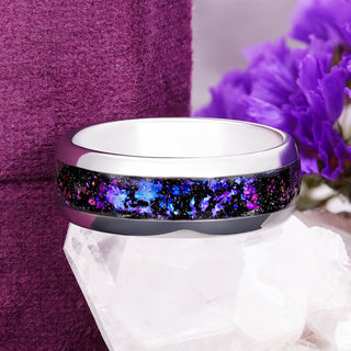 Orion Nebula fire opal men's band in silver tungsten with purple, blue and pink galaxy inlay, resting on a quartz crystal