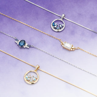 Three necklaces with pendants on a purple background