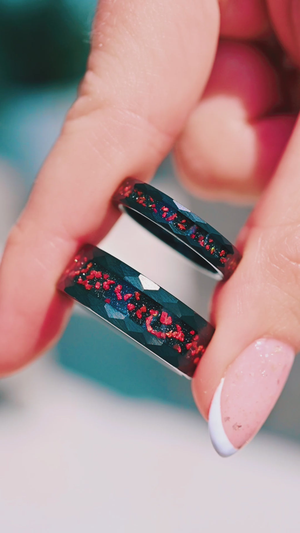 Video of the red fire opal couples ring set by Aquamarise, shown in motion