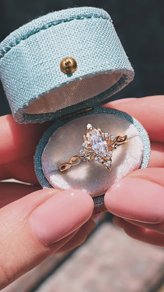 Video of the marquise butterfly engagement ring in solid 14K yellow gold by Aquamarise Gold, presented in its ring box