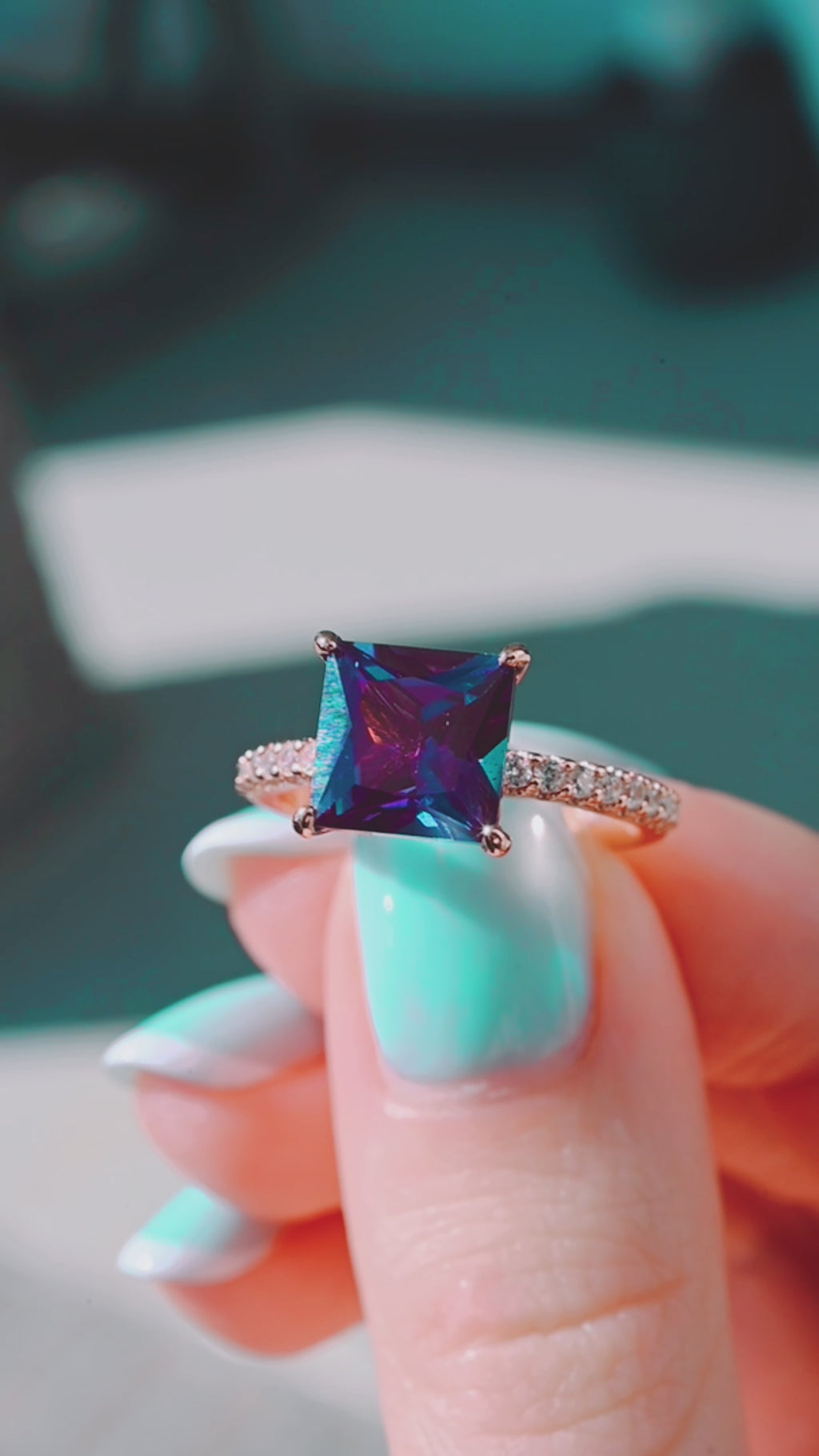 Product video of the Princess Cut Alexandrite Engagement Ring in 14K Solid Rose Gold by Aquamarise, showing the princess-cut alexandrite and its color shift.