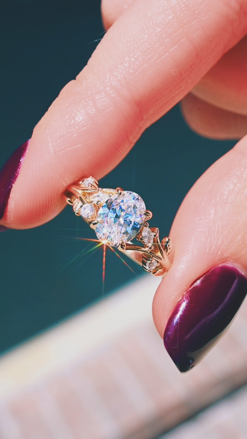 Product video of the Oval Lab-Grown Diamond Leaf & Vine Engagement Ring in Solid 14K Yellow Gold by Aquamarise, showing the oval diamond among leaf and vine detailing.