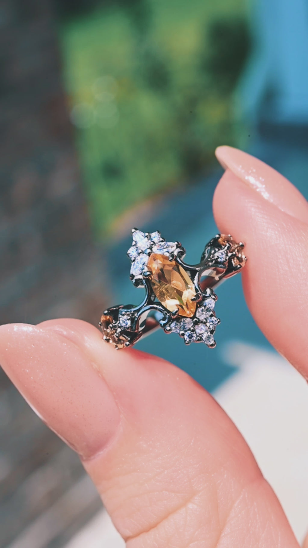 Artemisia marquise natural citrine engagement ring in black ruthenium turning in the light between fingertips