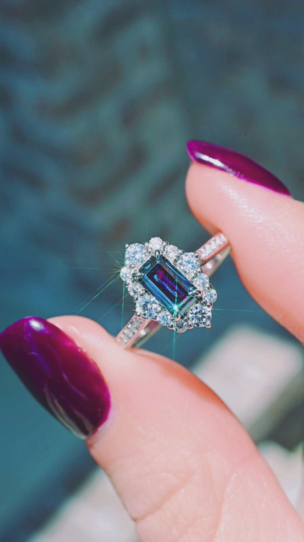 Product video of the Emerald Cut Alexandrite Engagement Ring in 14K White Gold by Aquamarise, showing the color-change alexandrite in an emerald cut.