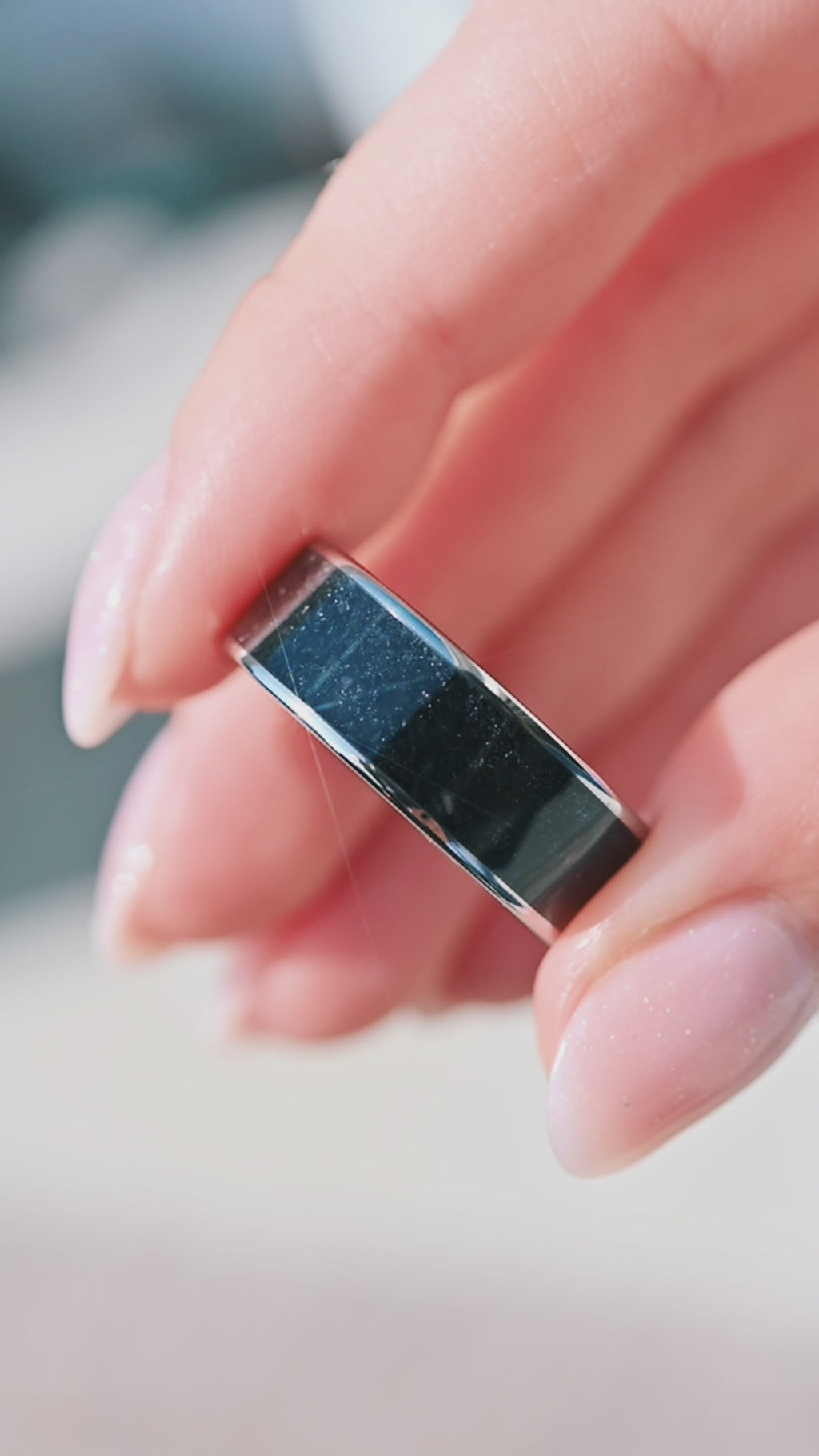 Video of a black onyx tungsten wedding band by Aquamarise, shown in motion