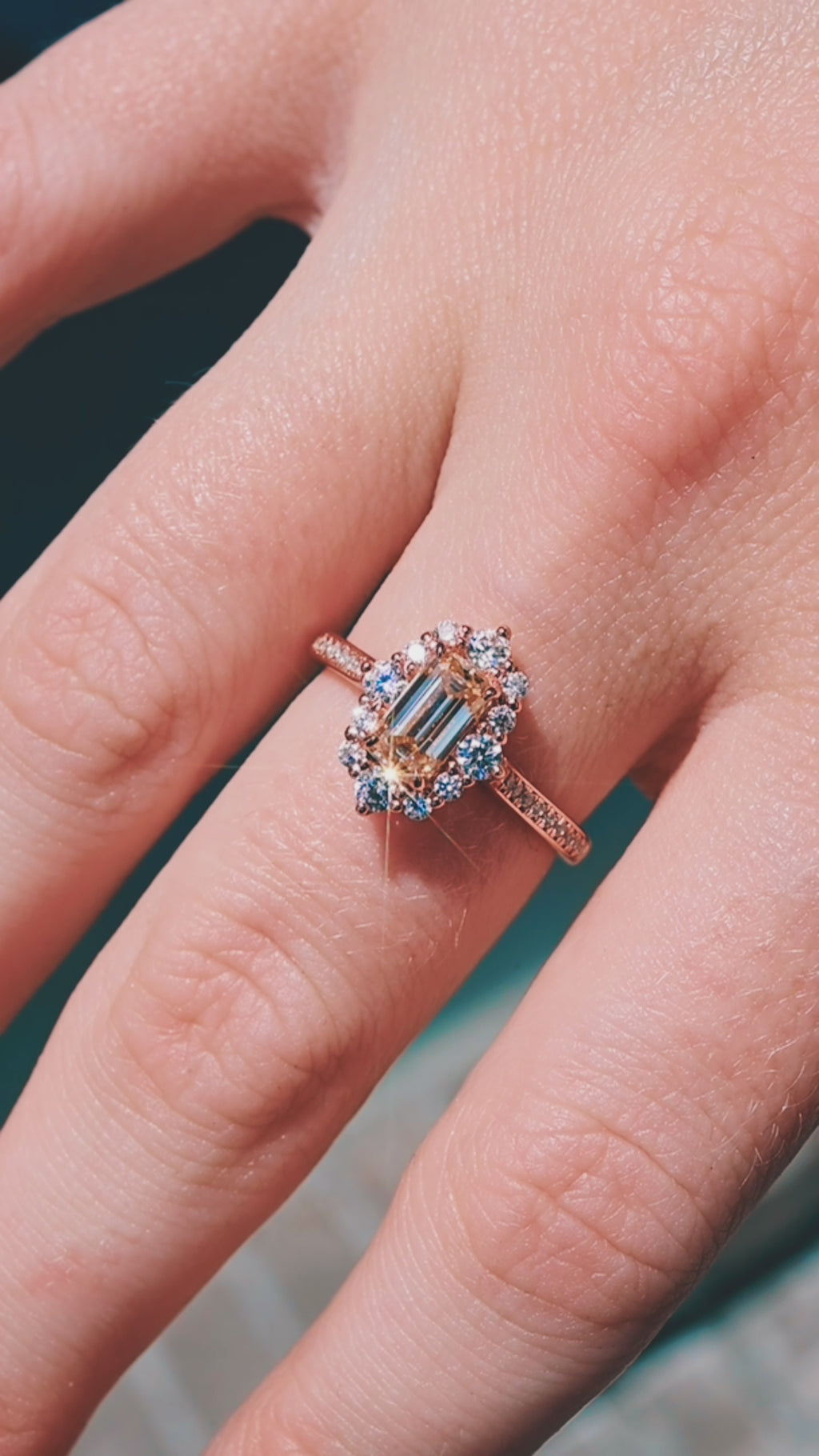 Product video of the Emerald Cut Champagne Moissanite Engagement Ring in Solid 14K Rose Gold by Aquamarise, showing the emerald-cut champagne moissanite on a rose gold band.