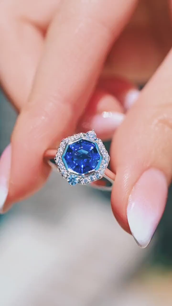 Video of the Asscher Cut Art Deco Bezel Set Blue Sapphire Ring in Sterling Silver by Aquamarise, shown sparkling in motion