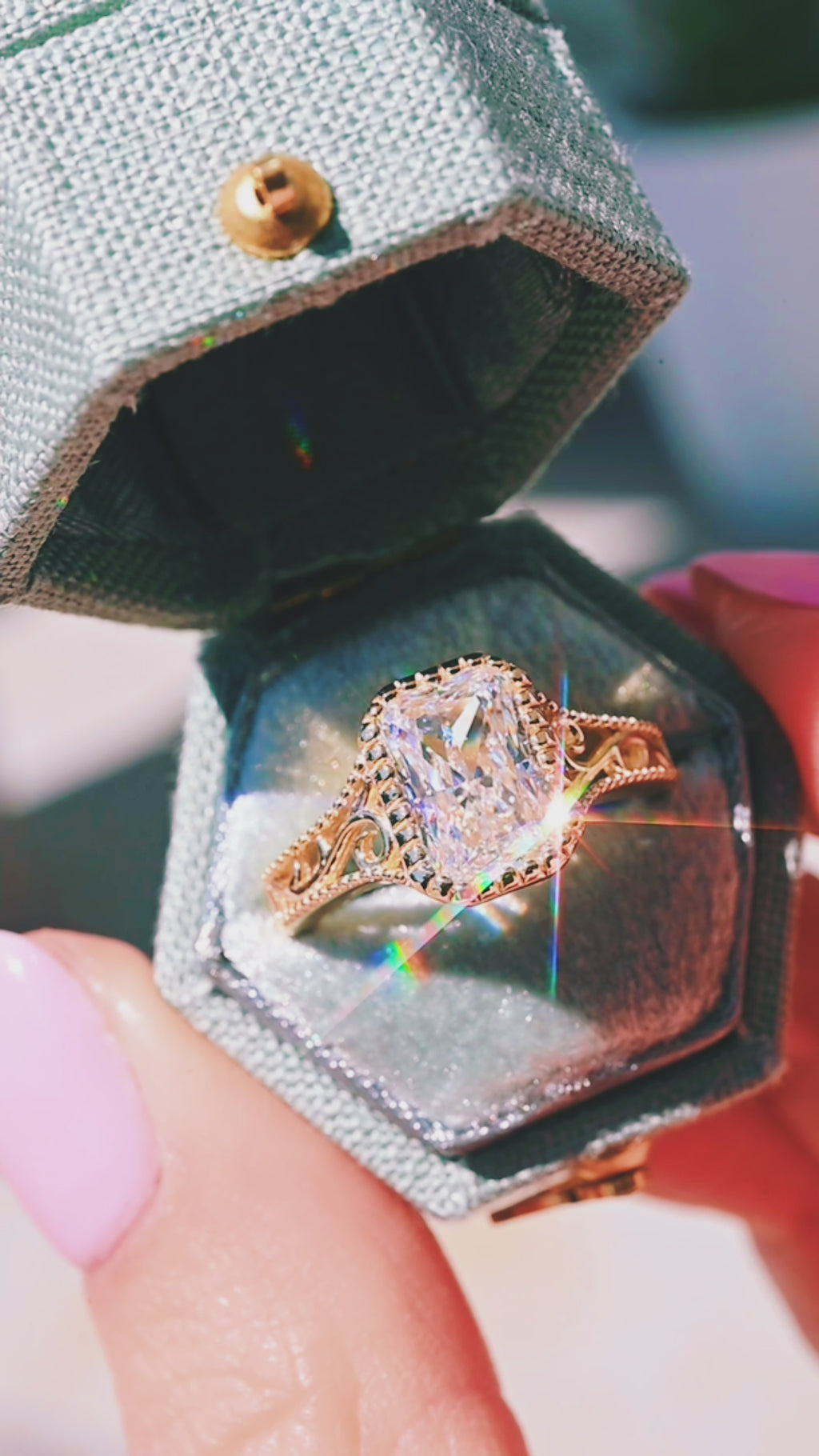 Product video of the Lab Grown Diamond Engagement Ring in Solid 14K Yellow Gold by Aquamarise, showing the radiant-cut lab-grown diamond and vintage detailing on the band.