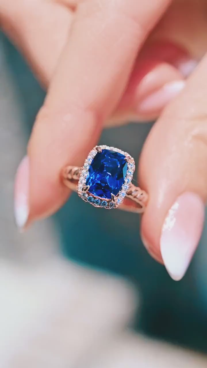 Hand holding Blue Sapphire Engagement Ring Cushion Cut Ceylon Sapphire 