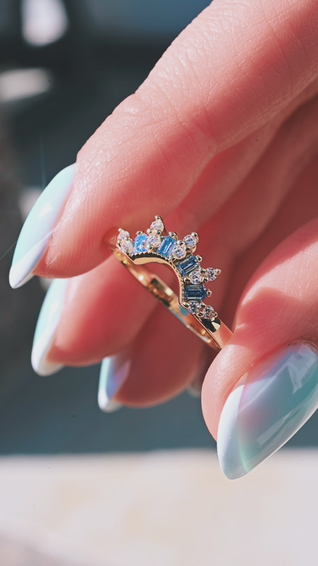 Product video of the Blue Moissanite Crown Band in 14K Yellow Gold by Aquamarise, showing the blue moissanite accents along the curved crown band.